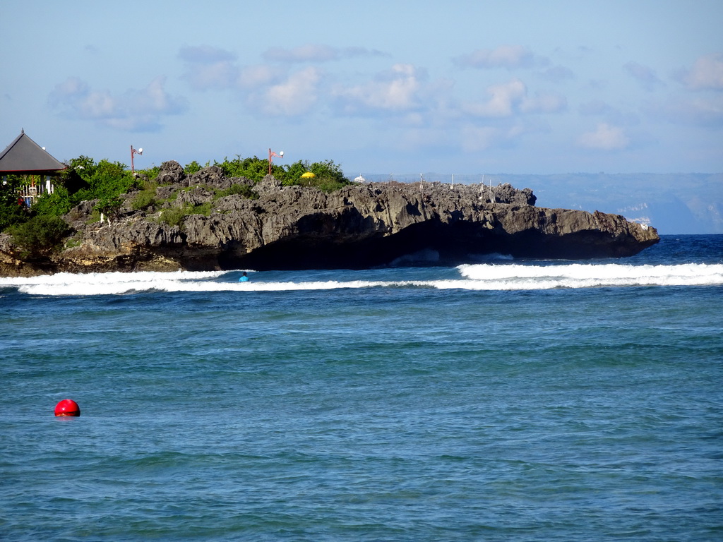 The Pura Bias Tugel temple at Peninsula Island and the Lombok Strait, viewed from the beach of the Inaya Putri Bali hotel