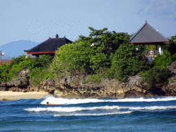 The Pura Bias Tugel temple at Peninsula Island and the Lombok Strait, viewed from the beach of the Inaya Putri Bali hotel