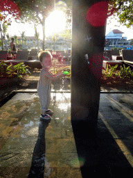 Max playing with water at the beach of the Inaya Putri Bali hotel