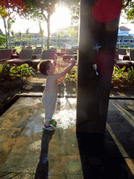 Max playing with water at the beach of the Inaya Putri Bali hotel