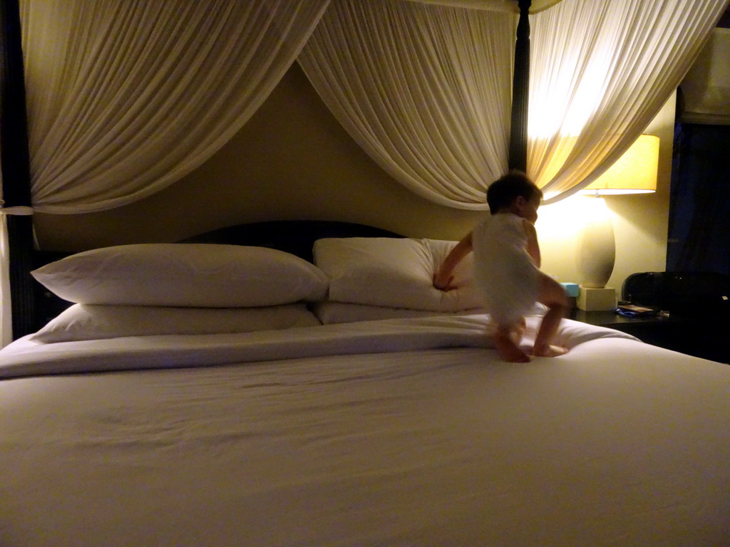 Max on a bed at the Kayumanis Nusa Dua Private Villa & Spa, at sunset