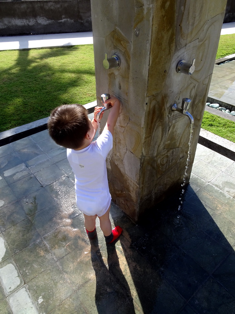 Max playing with water at the swimming pool of the Inaya Putri Bali hotel