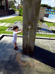 Max playing with water at the swimming pool of the Inaya Putri Bali hotel