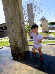 Max playing with water at the swimming pool of the Inaya Putri Bali hotel
