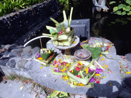 `Canang Sari` offering at the fountain at the grassland of the Inaya Putri Bali hotel