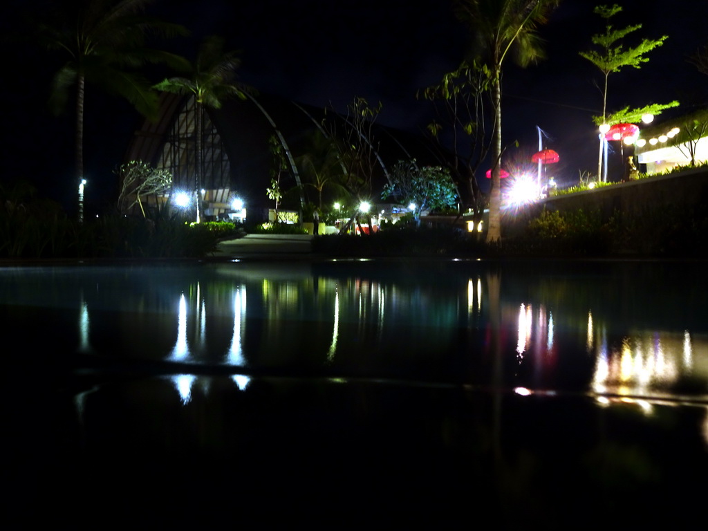 Swimming pool and lobby building of the Inaya Putri Bali hotel, by night