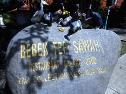 Rock with Duck statues in front of the Bebek Tepi Sawah restaurant at the Bali Collection shopping mall