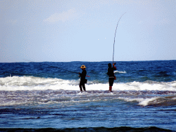 Fishermen at the beach of the Inaya Putri Bali hotel, during low tide