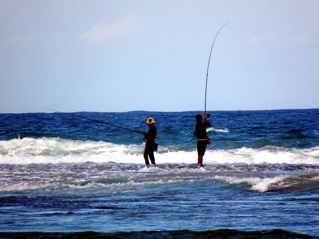 Fishermen at the beach of the Inaya Putri Bali hotel, during low tide