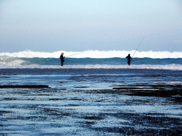 Fishermen at the beach of the Inaya Putri Bali hotel, during low tide