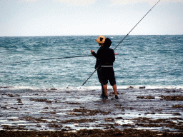 Fishermen at the beach of the Inaya Putri Bali hotel, during low tide