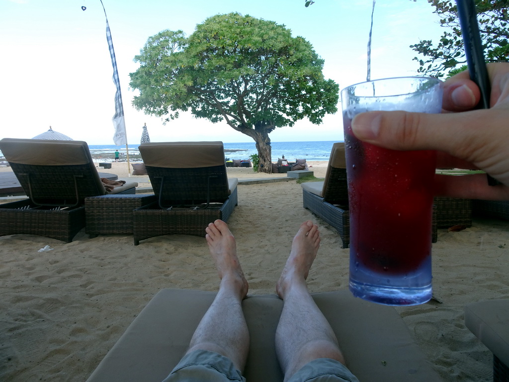 Tim with a drink at the beach of the Inaya Putri Bali hotel