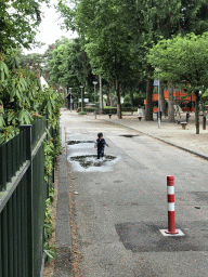 Max playing with water on a street at the Roompot De Katjeskelder holiday park