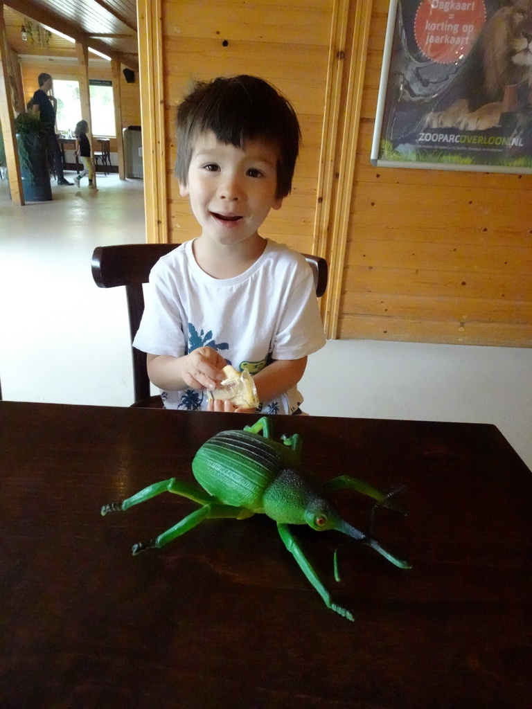 Max with a bug toy at the restaurant at the Headquarter area at ZooParc Overloon