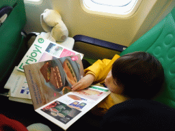 Max reading the menu at the airplane from Rotterdam