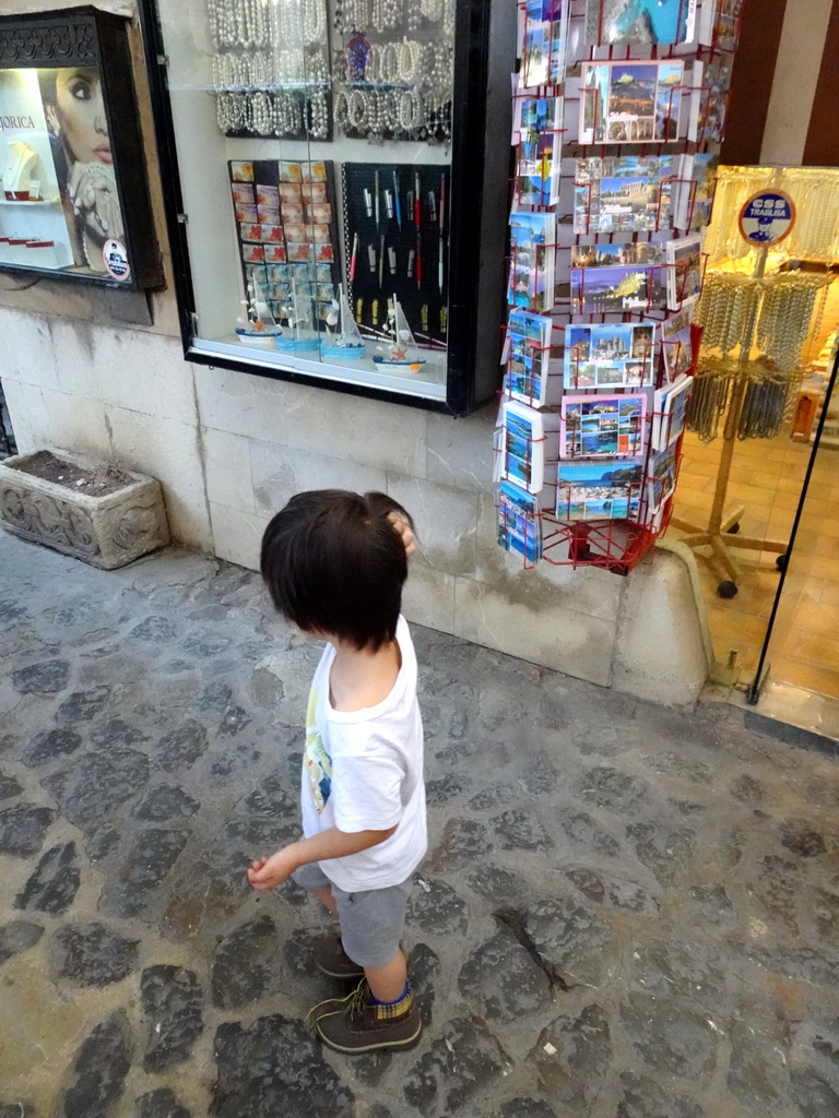 Max in front of a souvenir shop at the Plaça de la Seu square