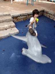 Max with a Stingray toy on a Hammerhead Shark statue at the Play Area at the Palma Aquarium