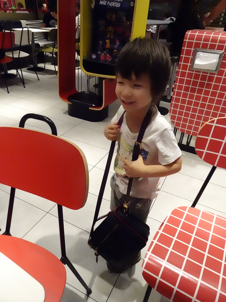 Max with Miaomiao`s purse at the McDonald`s restaurant along the way to Cala d`Or