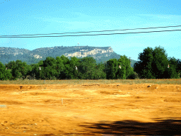 Hills with a tower to the east of the town of Llucmajor, viewed from the rental car on the Ma-19 road