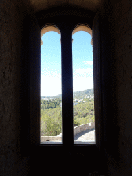 Window at the first floor of the Castell de Bellver castle, with a view on the hills on the west side