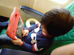 Max playing with iPad in the airplane to Rotterdam