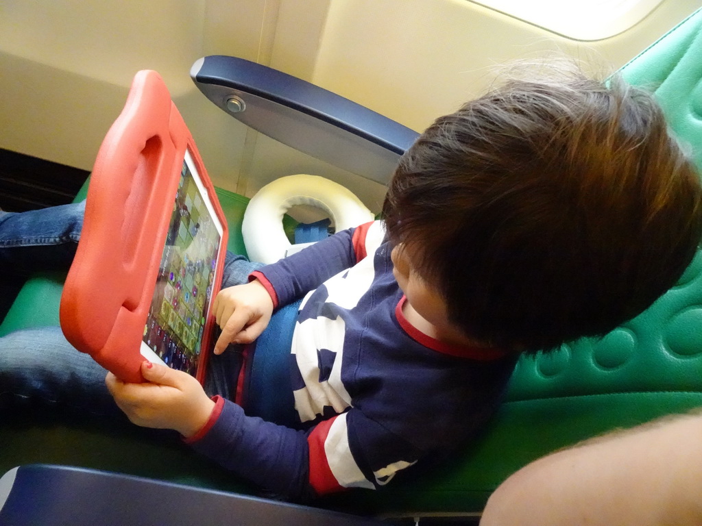 Max playing with iPad in the airplane to Rotterdam