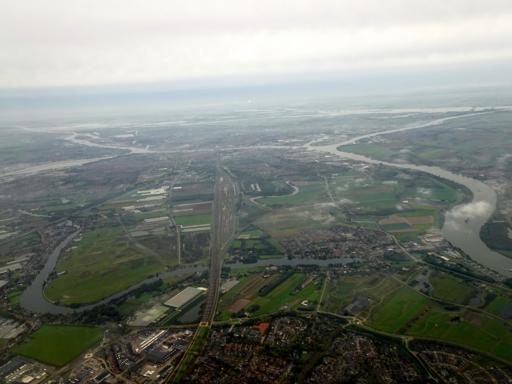 The Oude Maas river, the Kijfhoek marshalling yard and the city of Dordrecht, viewed from the airplane to Rotterdam