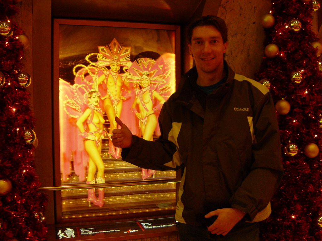 Tim at a photo near the entrance of the Moulin Rouge, by night