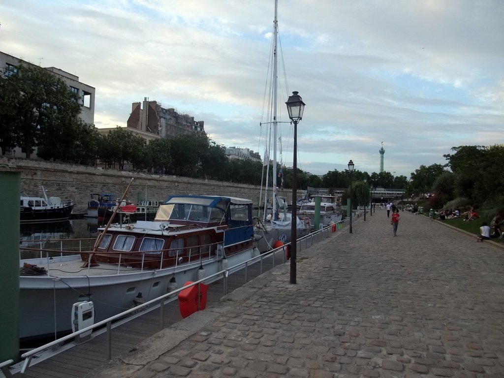 Boats in the Bassin de l`Arsenal basin and the Colonne de Juillet column