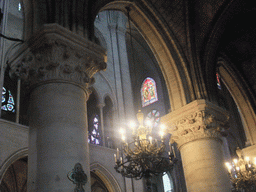 Pillars, chandelier and stained glass window in the Cathedral Notre Dame de Paris