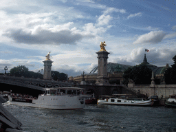 Boats in the Seine river, the Pont Alexandre-III bridge over the Seine river and the Grand Palais, viewed from the Seine ferry