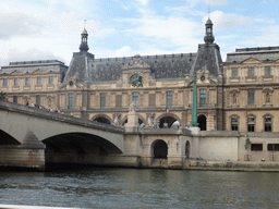 The Pont du Carousel bridge over the Seine river and the south side of the Louvre Museum, viewed from the Seine ferry