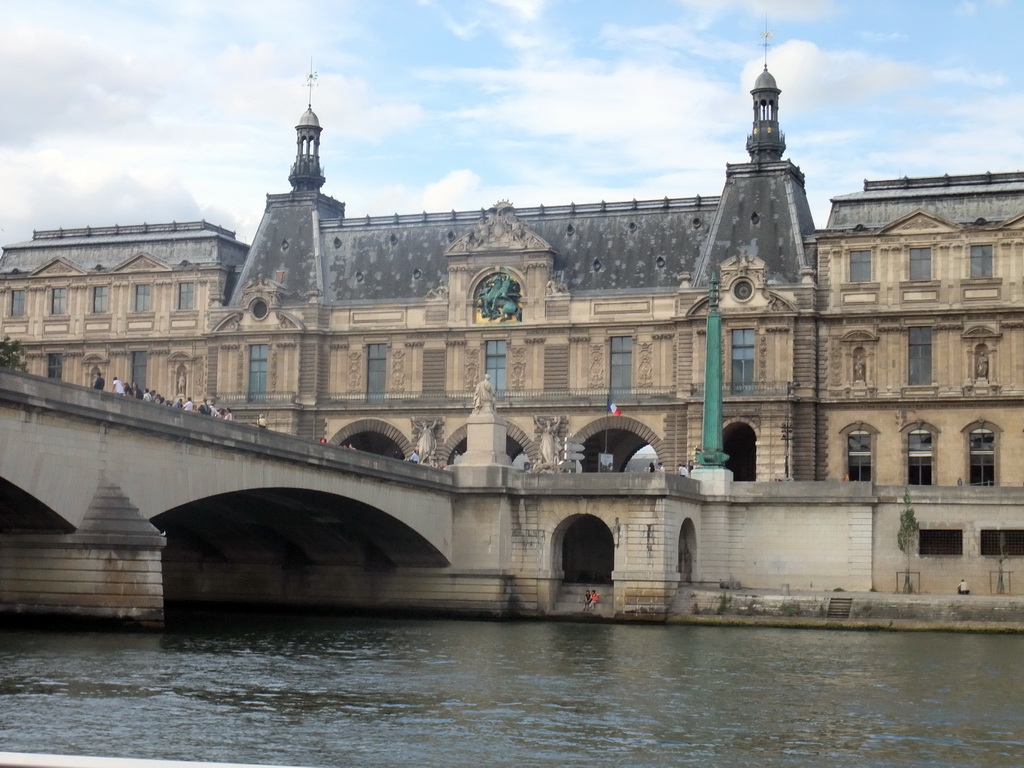 The Pont du Carousel bridge over the Seine river and the south side of the Louvre Museum, viewed from the Seine ferry
