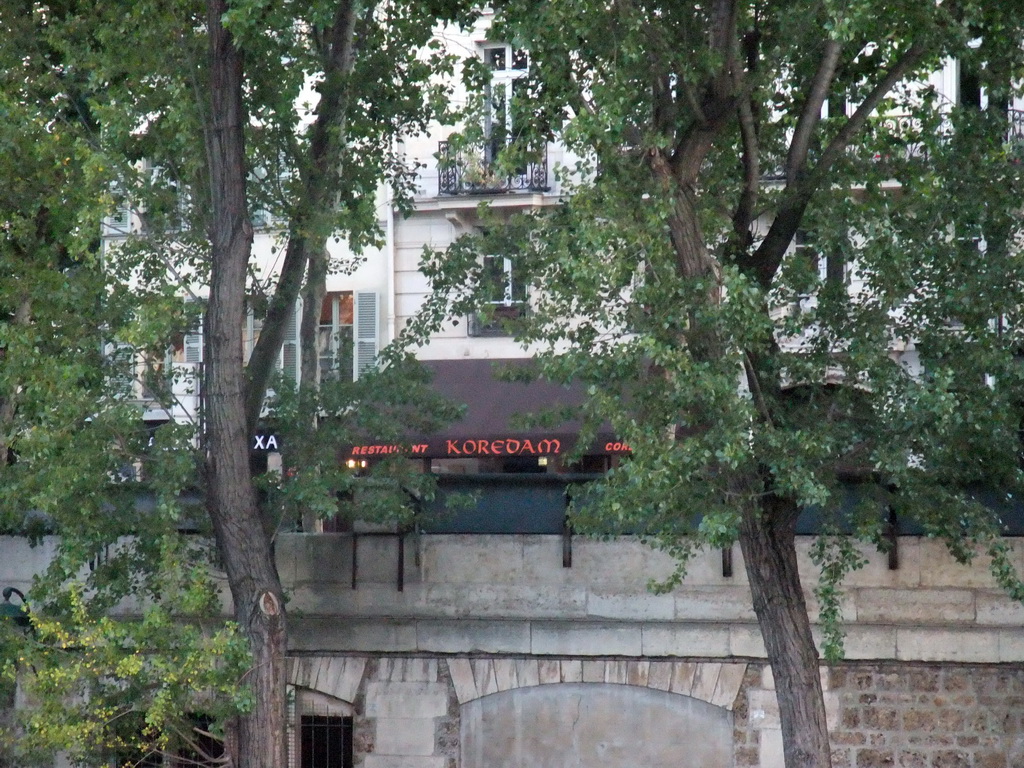 The Korean restaurant `Koredam` in the Quai de Montebello street, viewed from the gardens of the Cathedral Notre Dame de Paris
