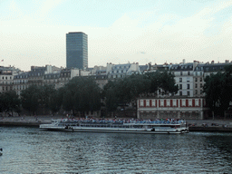 Boat in the Seine river and the Tour Zamansky tower, viewed from the Pont Saint-Louis bridge