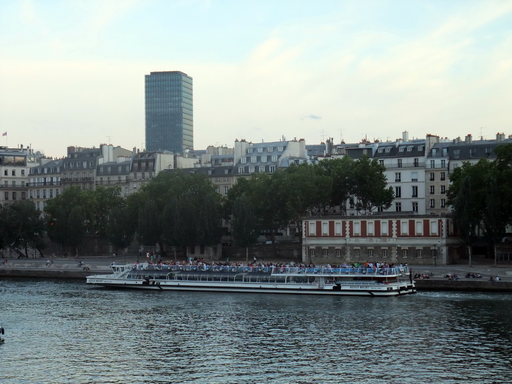 Boat in the Seine river and the Tour Zamansky tower, viewed from the Pont Saint-Louis bridge