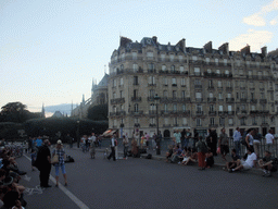 Street artists on the Pont Saint-Louis bridge and the back side of the Cathedral Notre Dame de Paris