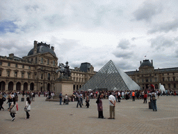 The Louvre Pyramid and the Equestrian statue of King Louis XIV at the Cour Napoleon courtyard, and the Louvre Museum