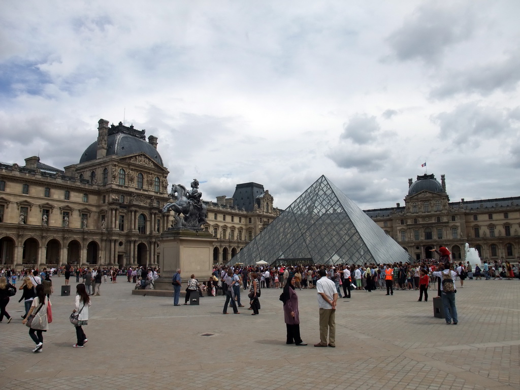 The Louvre Pyramid and the Equestrian statue of King Louis XIV at the Cour Napoleon courtyard, and the Louvre Museum