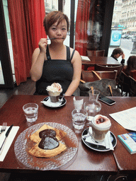 Miaomiao with coffee in the restaurant `Le Comptoir du Panthéon` in the Rue Soufflot street