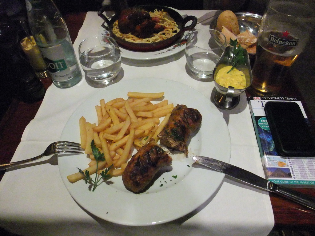 Andouillette sausage with fries and porc in the restaurant `Maison de l`Alsace` in the Avenue des Champs-Élysées