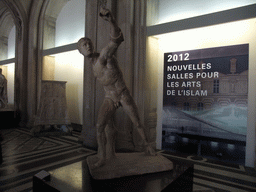 Greek statue `The Borghese Gladiator` in the Galerie Daru room on the Ground Floor of the Denon Wing of the Louvre Museum