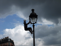 Street artist with football, hanging on a street light on top of the Montmartre hill