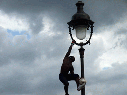 Street artist with football, hanging on a street light on top of the Montmartre hill