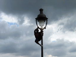 Street artist with football, hanging on a street light on top of the Montmartre hill