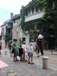 Stiltwalker in the Rue de l`Abreuvoir street on the Montmartre hill