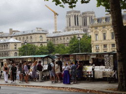 Street merchants at the Quai de la Mégisserie street, with a view on the Conciergerie building and the Cathedral Notre Dame de Paris