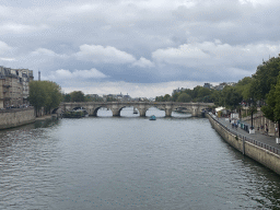 The Pont Neuf bridge over the Seine river and the Eiffel Tower, viewed from the Pont au Change bridge