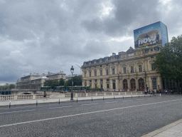 The Pont au Change bridge over the Seine river and the Greffe du Tribunal de Commerce de Paris building with a commercial poster for the FIFA World Cup 2022