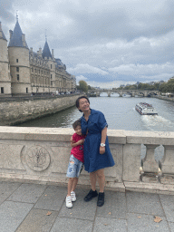 Miaomiao and Max on the Pont au Change bridge over the Seine river, with a view on the Conciergerie building and the Pont Neuf bridge